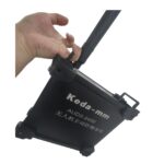 Hand holding a black Keda - mm AUDS - 2458 drone jammer suitcase