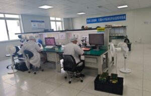Keda workers in white suits doing R & D work in a lab