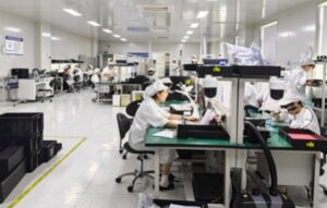 Keda's workers assembling and testing drone jammer modules on a production line