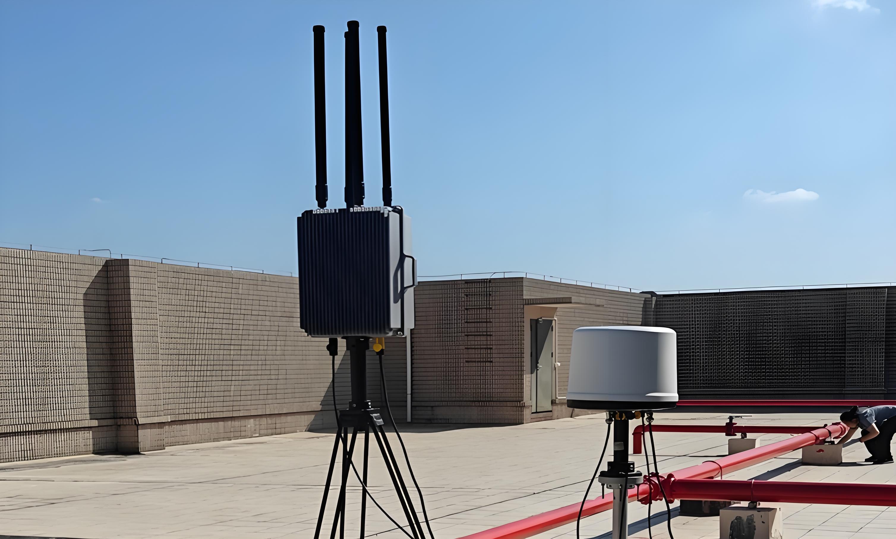 Anti - drone systems on a rooftop with a person working nearby